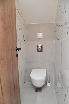a bathroom with a white toilet in a room at Istros luxury house in Krčedin