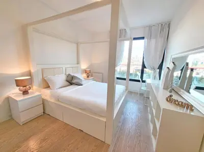 a white bedroom with a bed and a large window at Metropoliten - Aria Lux Apartments BW in Belgrade