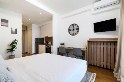 a bedroom with a bed and a clock on the wall at inJoy in Belgrade