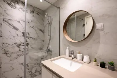 a bathroom with a sink and a shower with a mirror at inJoy in Belgrade