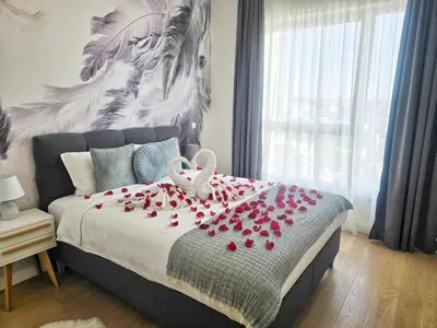 a bedroom with a bed with red roses on it at Simphonia Lux Apartments BW in Belgrade