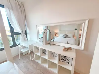 a bedroom with a large mirror on the wall at Simphonia Lux Apartments BW in Belgrade