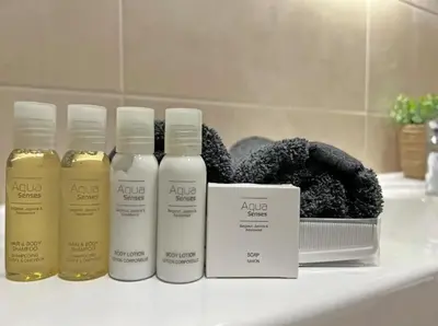 a group of three bottles of hair products on a bathroom counter at Simphonia Lux Apartments BW in Belgrade