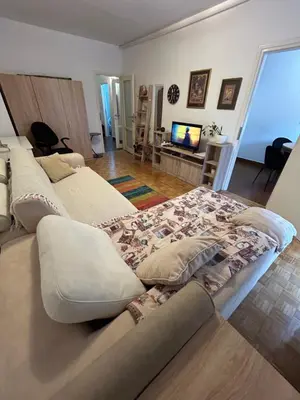 two beds in a living room with a television at Apt 1944 in Belgrade