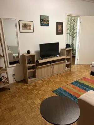 a living room with a flat screen tv on a entertainment center at Apt 1944 in Belgrade