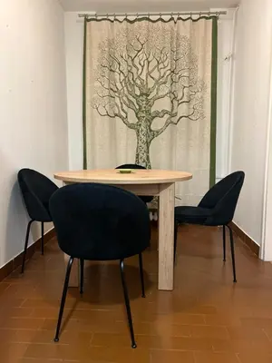 a table with two chairs and a tree curtain at Apt 1944 in Belgrade