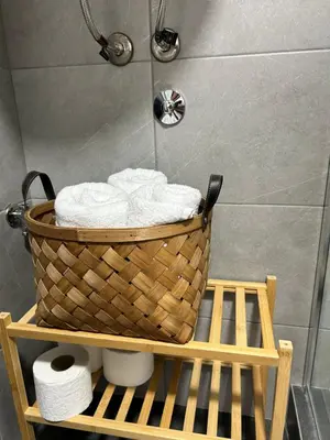 a basket of towels on a shelf in a bathroom at La Hitana in Lazarevac