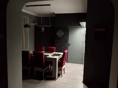 a dining room with a table and red chairs at Central Point Belgrade in Belgrade