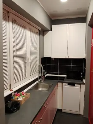 a kitchen with white cabinets and a sink at Central Point Belgrade in Belgrade