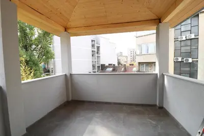 an empty balcony with a wooden roof and two windows at Grandeur Slavija in Belgrade