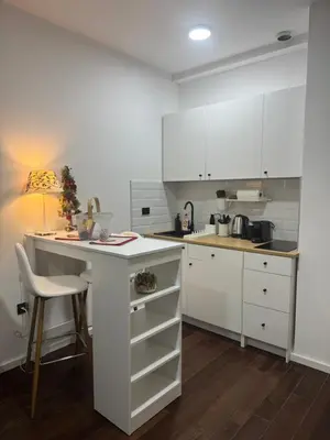 a kitchen with white cabinets and a white counter top at Cozy apartment Kosmaj Residence in Rogača