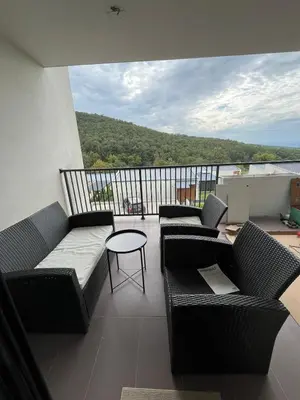 a balcony with couches and a table and a view at Cozy apartment Kosmaj Residence in Rogača