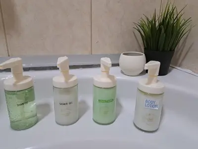 a group of four bottles sitting on a bathroom counter at Wolf Belgrade in Belgrade