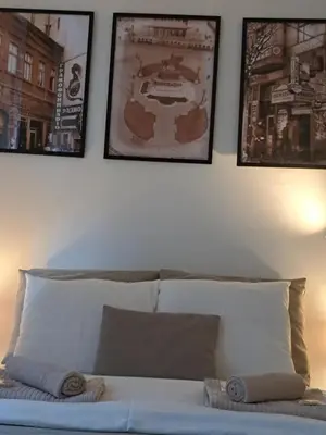 a bedroom with a bed with three pictures on the wall at Wolf Belgrade in Belgrade