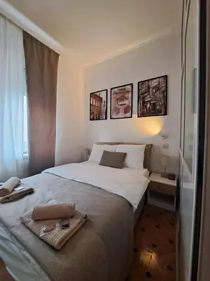 a bedroom with a bed with a towel on it at Wolf Belgrade in Belgrade