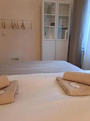 a bedroom with a bed with towels on it at Wolf Belgrade in Belgrade