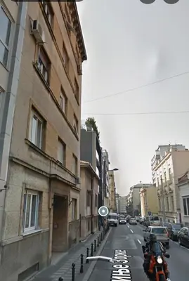 a street with cars parked on the side of a building at Wolf Belgrade in Belgrade