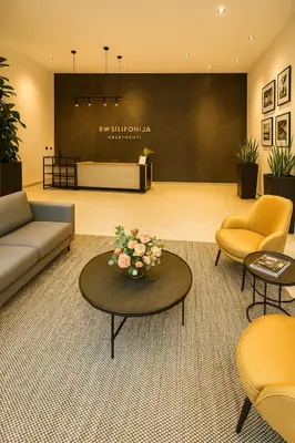 a lobby with a couch and chairs and a table at Waterfront Studio Blue Lagoon in Belgrade