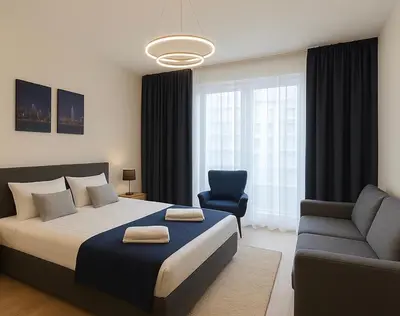 a bedroom with a large bed and a blue chair at Waterfront Studio Blue Lagoon in Belgrade