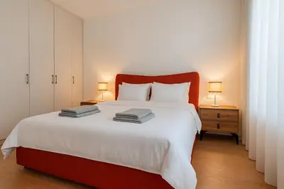 a bedroom with a large bed with a red headboard at Belgrade Waterfront - Urban Harmony Apartments in Belgrade