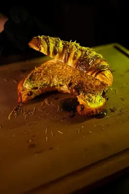 a sandwich is cut in half on a cutting board at Belgrade Waterfront - Urban Harmony Apartments in Belgrade