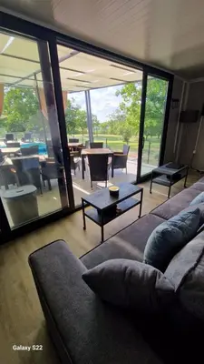 a living room with a couch and a table at Niki Hill in Železnička Stanica Karlovački Vinogradi