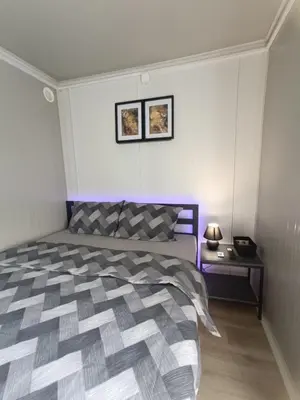a bedroom with a large bed with purple accents at Niki Hill in Železnička Stanica Karlovački Vinogradi