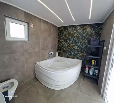 a bathroom with a large white tub in a room at Niki Hill in Železnička Stanica Karlovački Vinogradi