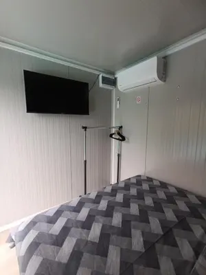 a room with a bed and a flat screen tv at Niki Hill in Železnička Stanica Karlovački Vinogradi