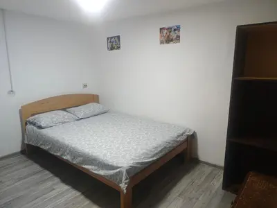 a small bed in a room with a white wall at hometown in Pančevo
