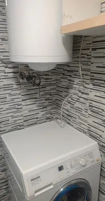 a washer and dryer in a bathroom with a wall at hometown in Pančevo