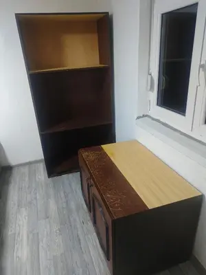 a room with a wooden desk and a window at hometown in Pančevo