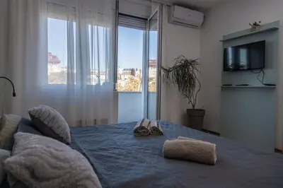 a bedroom with a bed with towels and shoes on it at Old Town Panorama in Belgrade
