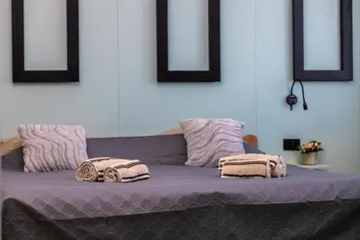 a purple bed with two towels on top of it at Old Town Panorama in Belgrade
