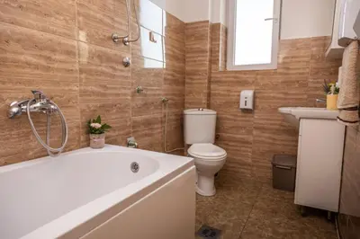 a bathroom with a tub and a toilet and a sink at Old Town Panorama in Belgrade