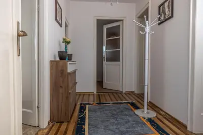 a hallway with a door and a rug on the floor at Old Town Panorama in Belgrade