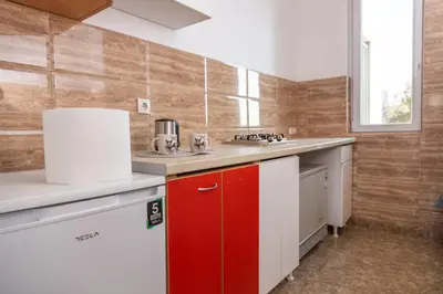 a kitchen with red and white cabinets and a sink at Old Town Panorama in Belgrade