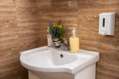 a bathroom sink with a soap dispenser on it at Old Town Panorama in Belgrade