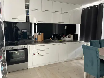 a kitchen with white cabinets and a stove at Apartman 100m2 in Belgrade