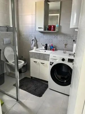 a bathroom with a washing machine and a sink at Apartman 100m2 in Belgrade