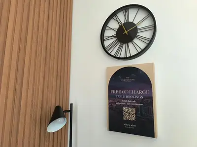 a clock on a wall with a poster and a picture at Gallery Mall View-studio in Belgrade