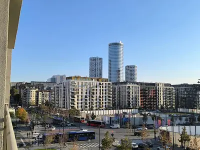 a view of a city with tall buildings and buses at Gallery Mall View-studio in Belgrade