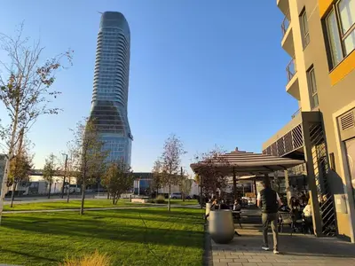 a tall building in a park with a building at Gallery Mall View-studio in Belgrade