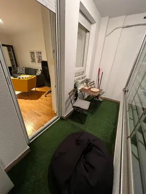 a view of a living room with a black umbrella on the floor at Belville city view in Belgrade