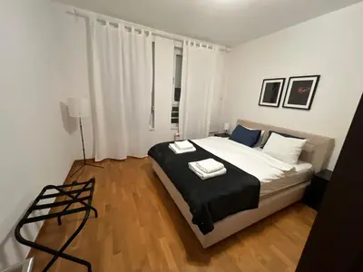 a bedroom with a bed with two towels on it at Belville city view in Belgrade