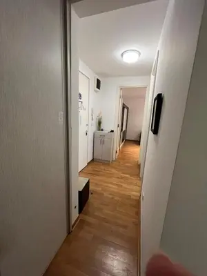 a hallway leading to a room with a hard wood floor at Belville city view in Belgrade