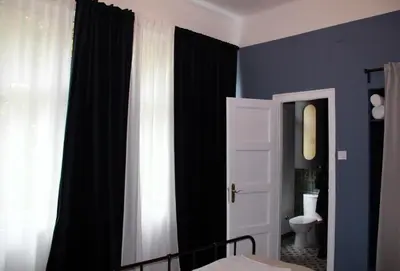 a bedroom with black and white curtains and a bed at Belgrade 1920 in Belgrade