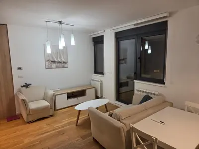 a living room with a couch and a table at Apartman-Stan in Belgrade
