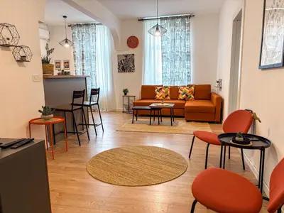 a living room with a couch and tables and chairs at Lukerly 2 in Belgrade