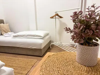 a living room with a vase with a plant on a table at Lukerly 2 in Belgrade